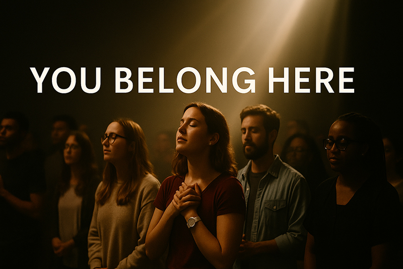A diverse group of people gathered outdoors in soft sunlight with beams of light and the words “You Belong Here.”